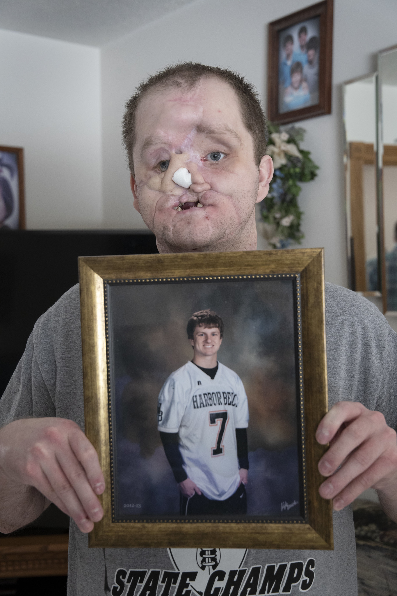 Derek Pfaff holds his high school senior portrait.