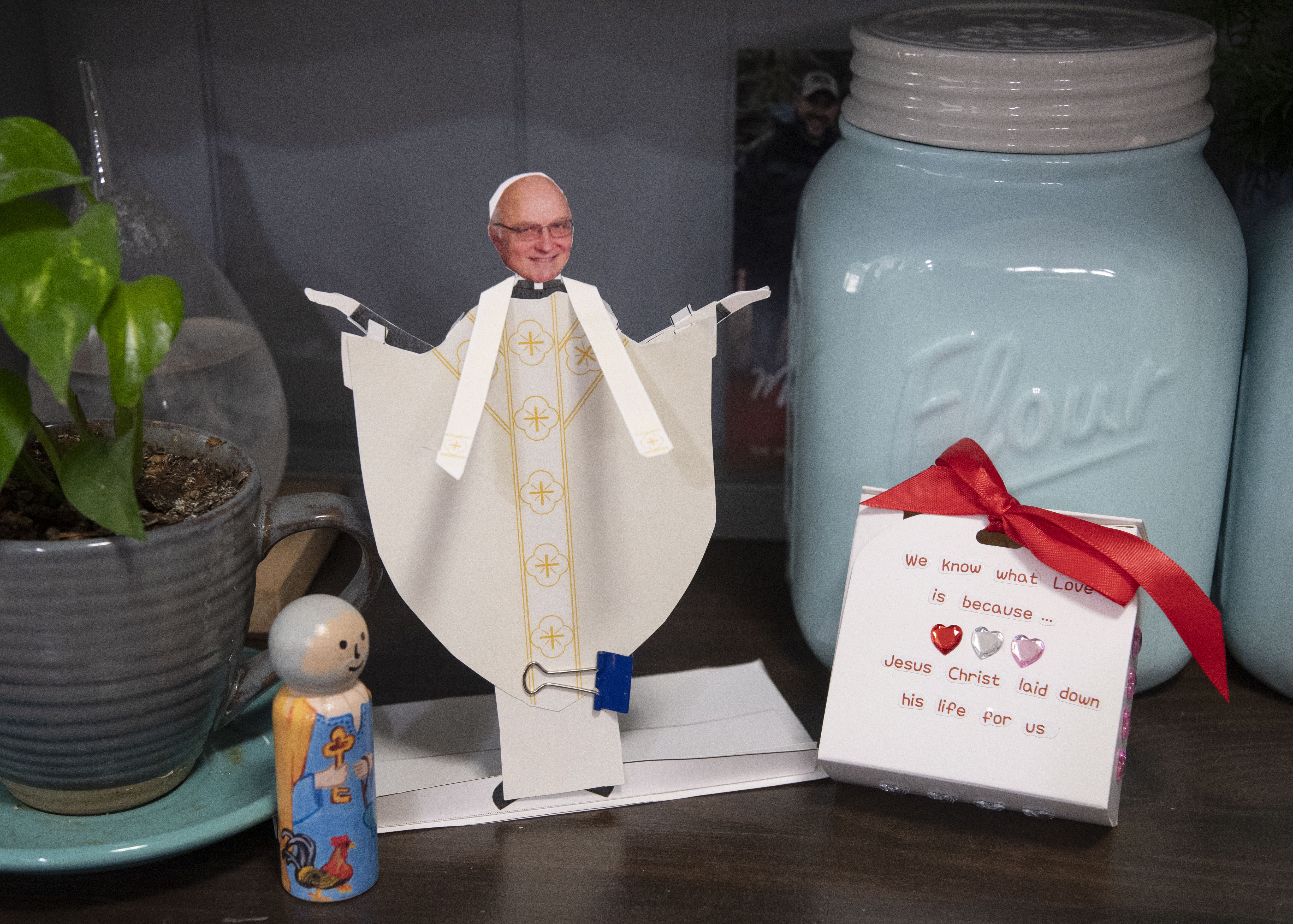 A paper doll of Father Dan Fox, OFM, can be dressed in vestments according to the liturgical season.
